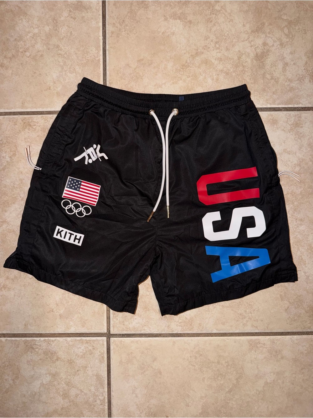 Kith Black USA Athletic Swim Shorts with Red White Blue Lettering